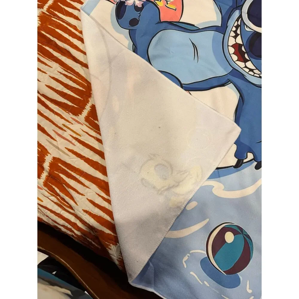 Stitch beach towel with Stitch wearing sunglasses on a live saver'